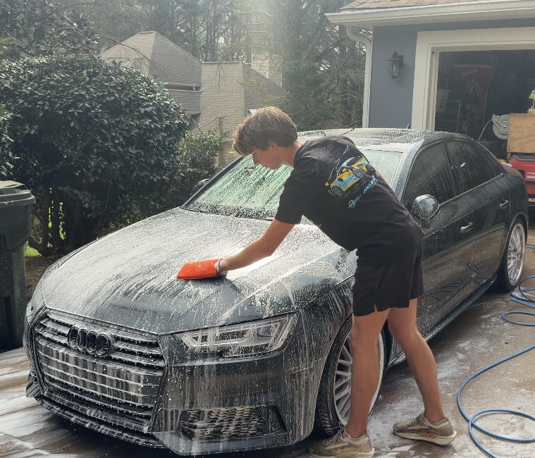Zane Phelps working on a vehicle at a customer's driveway
